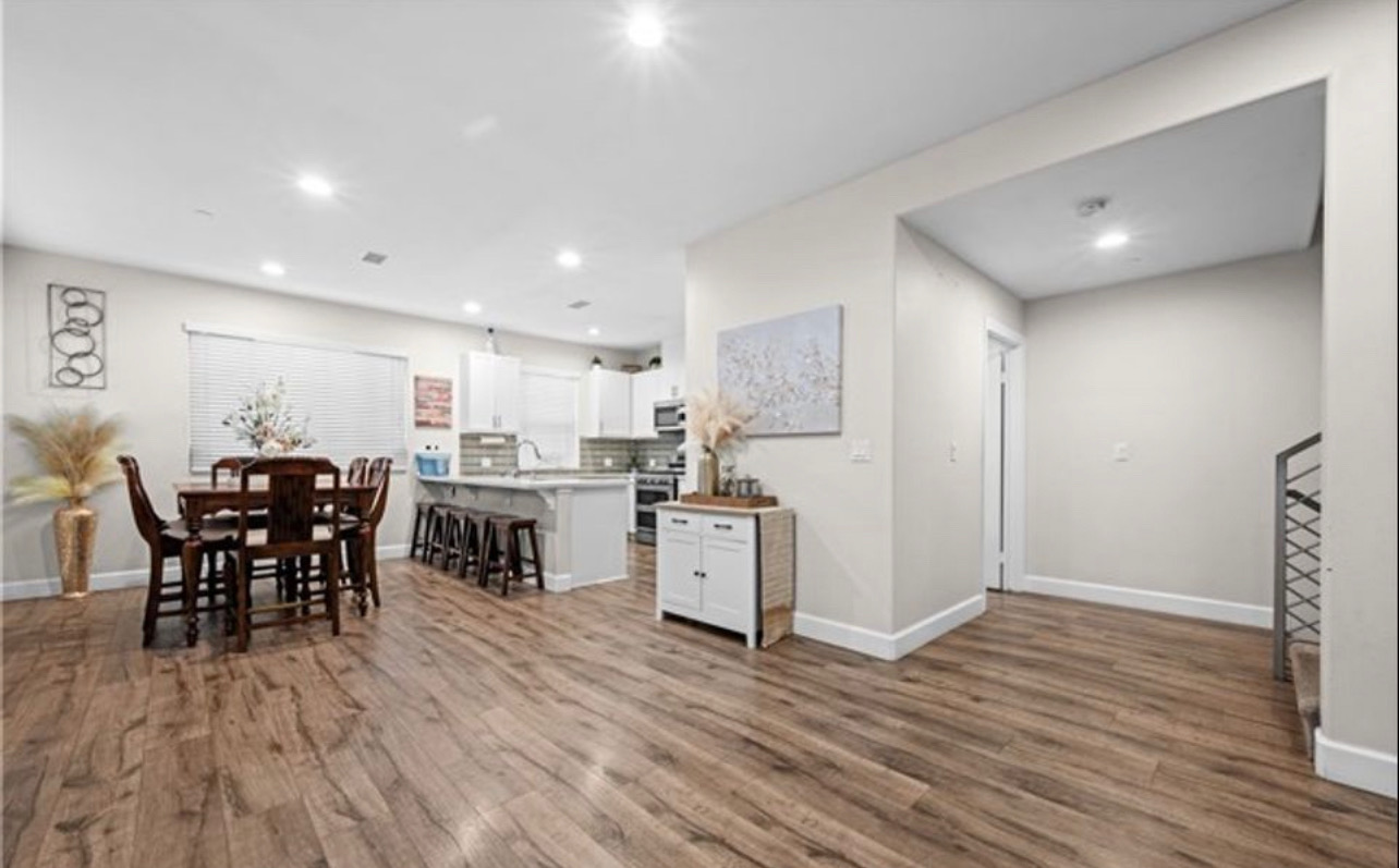Open dining and living area with hardwood floors